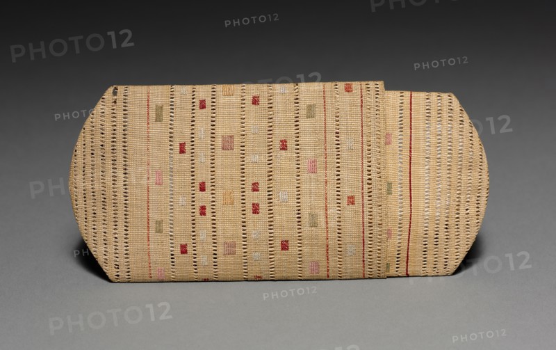 Cigarette or Needle Case, c 1875- 1917 (source unknown). Arctic, Aleut, Attu, Post-Contact. Plain twine, wild rye grass with crossed openwork, patterned twined start, intersecting layered spokes, and plaited finish; silk embroidery (catalogue card); overall: 2 x 11.5 cm (13/16 x 4 1/2 in.).