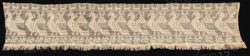 Fragment of a Border with Repeated Pattern of Fantastic Winged Animals, 16th-17th century. Italy, 16th-17th century. Needle lace, burato (twined ground and darned in two directions) and fringe; bleached linen (est.); overall: 28.8 x 143.2 cm (11 5/16 x 56 3/8 in.)