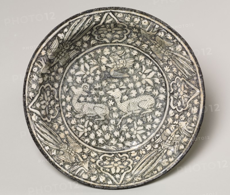 Ceramic dish with deer, phoenix, and lotus blossoms, 1300-1350. Iran, Sultanabad. Fritware with underglaze-painted design; overall: 7 x 32.6 cm (2 3/4 x 12 13/16 in.).