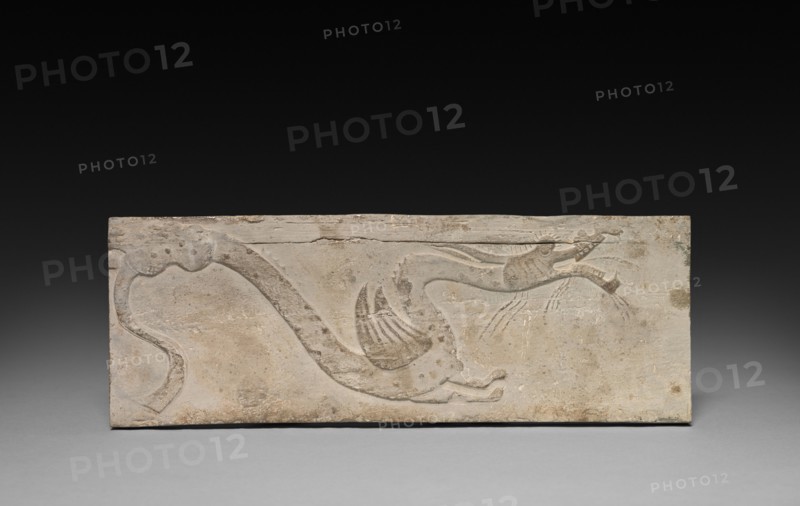 Relief with Dragon from a Funerary Stove Model, 206 BC - AD 220. China, from a tomb in Sian-fu, Shensi province, Han dynasty (202 BC-AD 220). Earthenware with relief decoration; overall: 10.2 x 27.4 cm (4 x 10 13/16 in.).
