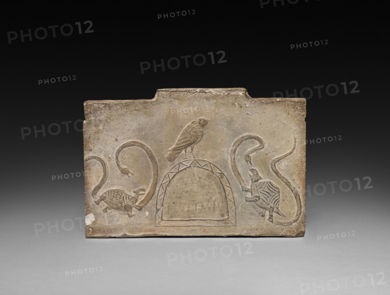 Panel from Model Cooking Stove:  Raven Flanked by Snake-Entwined Tortoises, 1st Century BC. China, from a tomb in Sian-fu, Shensi province, Western Han dynasty (202 BC-AD 9). Earthenware with impressed relief decoration; overall: 12.7 x 18.4 cm (5 x 7 1/4 in.).