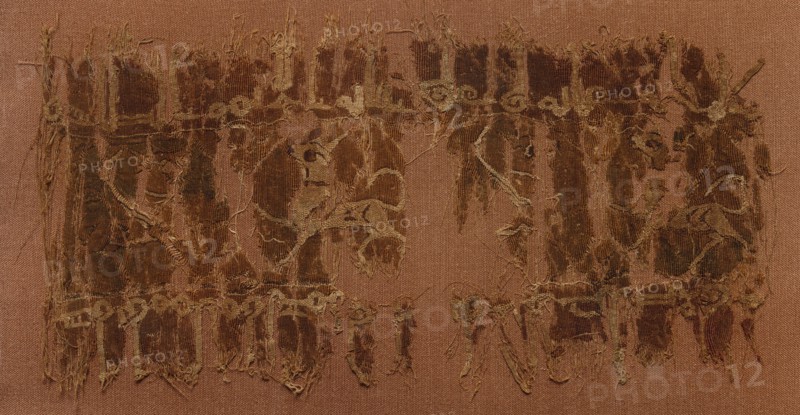 Fragment of a Tiraz, 1058 - 1060. Egypt, Fatimid period, Caliphate of al-Mustansir, AH 450-52, 11th Century. Tapestry (originally inwoven in a tabby ground); linen and silk; overall: 8.6 x 16.3 cm (3 3/8 x 6 7/16 in.).