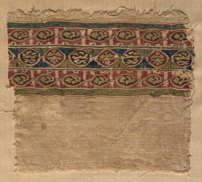 Fragment of a Tiraz-Style Textile, 1081 - 1101. Egypt, Fatimid period, Caliphate of al-Mustansir or al-Musta'li, c. AH 475-495, 11th-12th Century. Tabby ground with inwoven tapestry ornament; linen and silk; overall: 9.6 x 10.8 cm (3 3/4 x 4 1/4 in.)