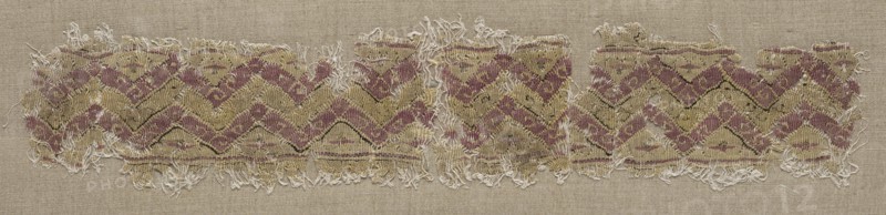 Fragment of a Tiraz-Style Textile, 1081 - 1101. Egypt, Fatimid period, latter part of Caliphate of al-Mustansir or of al-Musta'li, AH 475-495, 11th-12th Century. Tapestry (originally inwoven in a tabby ground); linen and silk; overall: 4.8 x 22.9 cm (1 7/8 x 9 in.)