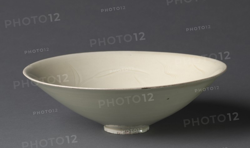 Bowl with Ducks among Waves and Reeds, 1100s. China, Hebei province, Quyang, Northern Song dynasty (960-1127). Cream-glazed porcelain with incised decoration, Ding ware ; diameter: 20.3 cm (8 in.); overall: 5.4 cm (2 1/8 in.).