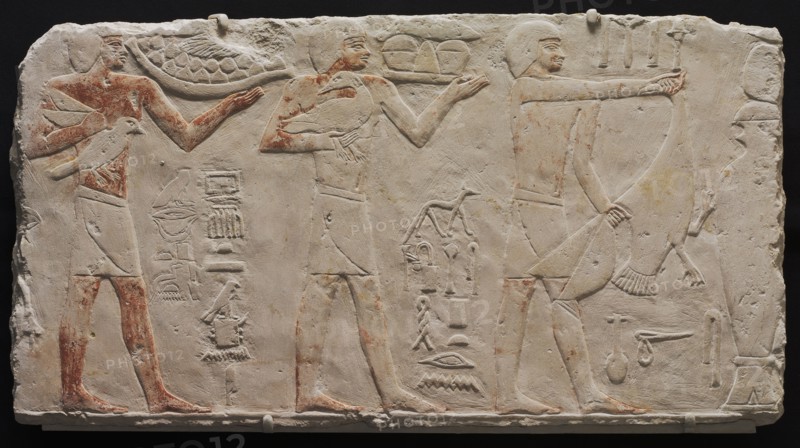 Relief of Three Offering Bearers, c. 2311-2281 BC. Egypt. Saqqara, Old Kingdom, Early Dynasty 6, 2311-2140 BC. Painted limestone; overall: 38.4 x 72.2 cm (15 1/8 x 28 7/16 in.).