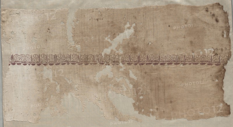 Fragment of a Tiraz, 1036 - 1044. Egypt, Fatimid period, Reign of Caliphate al-Mustansir, c. AH 427-436 (AD 1036-1044). Tabby ground with inwoven tapestry ornament; linen and silk; overall: 24.5 x 47.3 cm (9 5/8 x 18 5/8 in.).