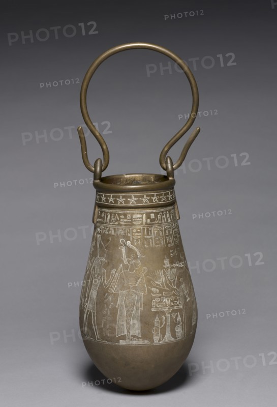 Decorated Situla, 305-30 BC. Egypt, Ptolemaic Dynasty. Bronze; diameter: 15.5 cm (6 1/8 in.); diameter of mouth: 10.2 cm (4 in.); overall: 28.3 cm (11 1/8 in.); with handle: 45.2 cm (17 13/16 in.).
