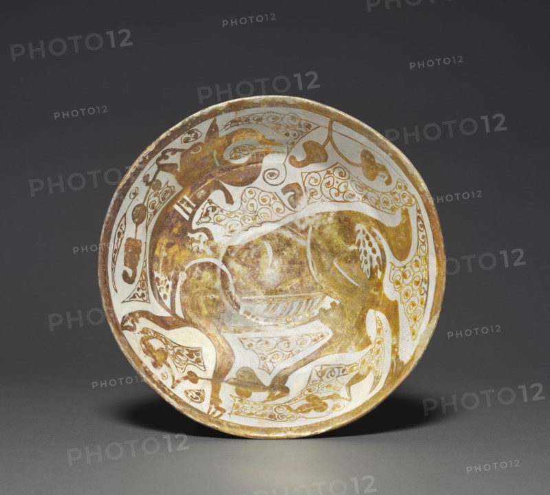 Luster Bowl with Antelope , 1000s. Egypt, Fustat (Old Cairo), Fatimid Period, 11th century. Earthenware with luster-painted design; diameter: 25.4 cm (10 in.); overall: 6.8 cm (2 11/16 in.).