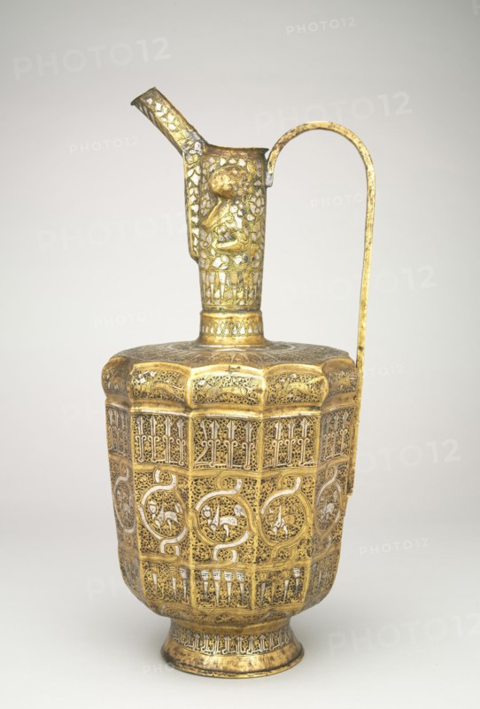 Twelve-sided Ewer with Sphinxes and Humanheaded Inscriptions, 1300-1350. Iran, Khurasan, Ilkhanid period, 14th century. Hammered sheet of brass inlaid with silver; overall: 44.8 cm (17 5/8 in.).