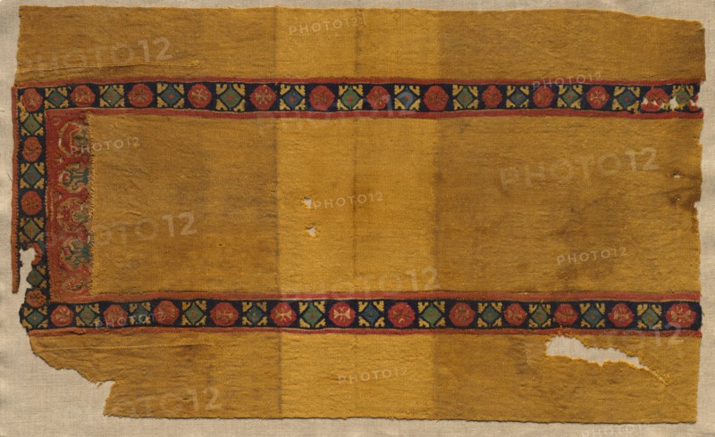 Fragment of a Tunic, 400s - 600s. Egypt, Byzantine period, 5th-7th century. Tabby weave with inwoven tapestry ornament, linen and wool; overall: 38.8 x 64.2 cm (15 1/4 x 25 1/4 in.)