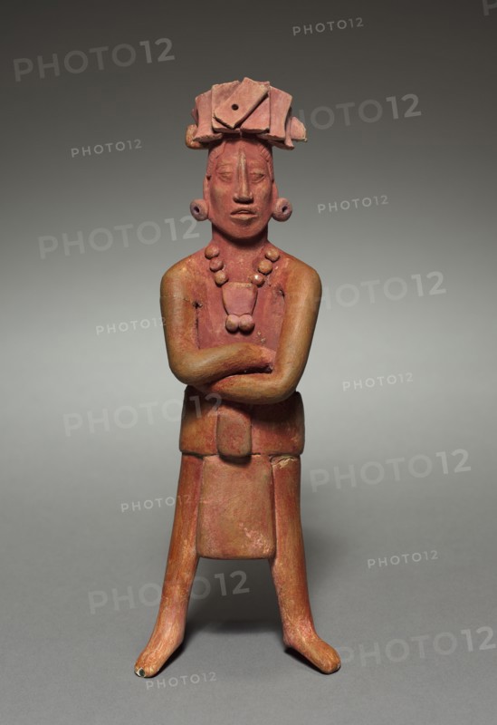 Figure, 317-987. Mexico, Jaina, Campeche, Maya, 4th-10th Century. Terracotta; overall: 23.5 x 10.5 x 7.5 cm (9 1/4 x 4 1/8 x 2 15/16 in.).