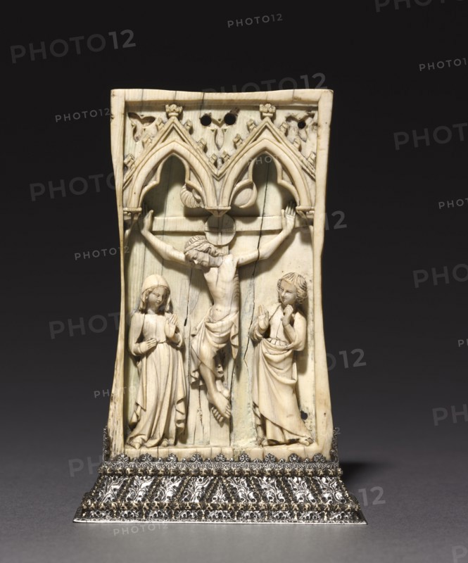 Plaque: The Crucifixion, c. 1345-1365. France or England, Gothic period, 14th century. Ivory, mounted in a silver stand (after 1919); without base: 10.8 x 6.6 cm (4 1/4 x 2 5/8 in.)