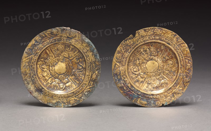 Pair of Ear Ornaments, c. 800-1370. Peru, North Coast, Sicán, 9th-14th century. Hammered and embossed gold alloy; diameter: 8.6 cm (3 3/8 in.); overall: 8.8 cm (3 7/16 in.).