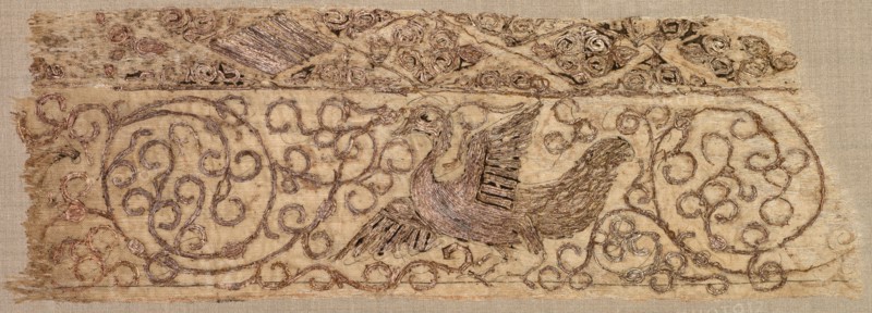 Embroidered fragment with bird among vines, 1100s. Iraq, Baghdad, Seljuq period. Plain weave: silk warp and cotton weft (mulham); embroidery, couched and split stitches: silk and metallic thread; overall: 7.3 x 21.6 cm (2 7/8 x 8 1/2 in.)