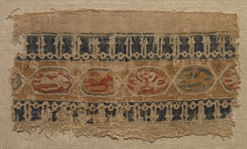 Fragment of a Tiraz-Style Textile, 1081 - 1094. Egypt, Fatimid period, Caliphate of al-Mustansir, c. AH 475-487 (A.D. 1081-1094). Tabby ground with inwoven tapestry ornament; linen and silk; overall: 10.5 x 18.5 cm (4 1/8 x 7 5/16 in.).
