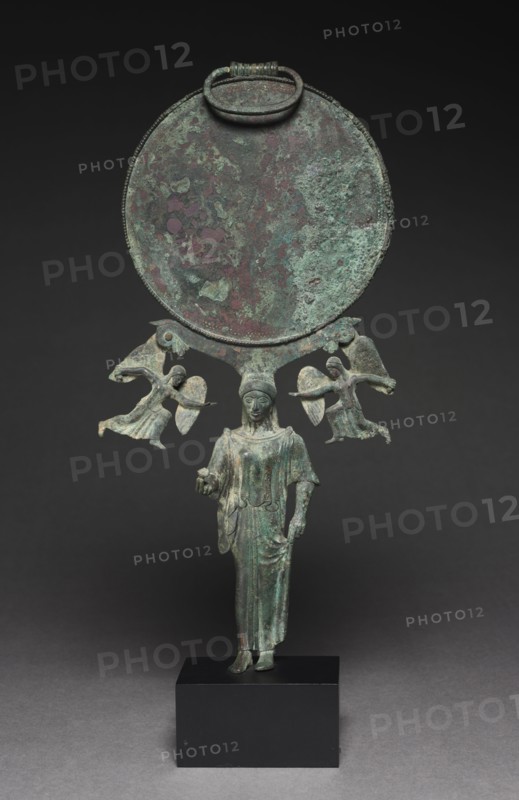 Mirror, c. 470-460 BC. Greece, Sicyon(?), 5th Century BC. Bronze; diameter: 15.3 cm (6 in.); overall: 38.8 cm (15 1/4 in.).