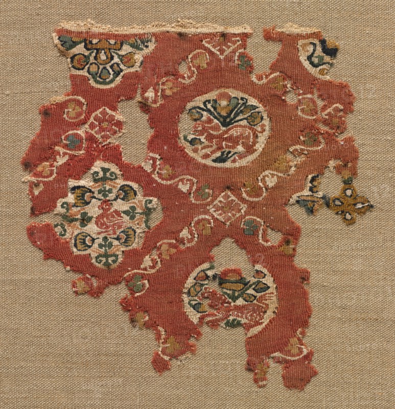 Tapestry with lattice of animals in medallions, 600s-700s. Egypt. Tapestry weave: wool and linen; overall: 14.6 x 13.1 cm (5 3/4 x 5 3/16 in.)