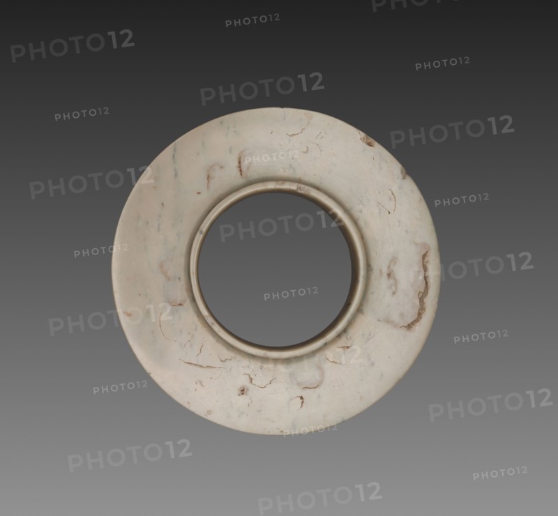 Collared Disk (Huan), c. 1600-1050 BC. China, Shang dynasty (c.1600-c.1046 BC). Jade (nephrite); diameter: 11.4 cm (4 1/2 in.); overall: 1.4 cm (9/16 in.); inner diameter: 8.6 cm (3 3/8 in.).