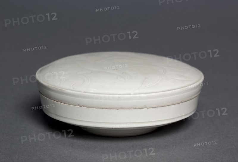Covered Box, 1100s. China, Hebei province, Quyang, Northern Song dynasty (960-1127) to Jin dynasty (1115-1234). Cream-glazed porcelain with incised decoration, Ding ware; diameter: 10.6 cm (4 3/16 in.).