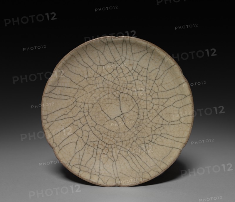 Lobed Dish:  Guan ware, 12th-14th Century. China, Zhejiang province, Southern Song Dynasty (1127-1279) - Yuan Dynasty (1271-1368). Glazed buff stoneware; diameter: 16.5 cm (6 1/2 in.); overall: 2.9 cm (1 1/8 in.).