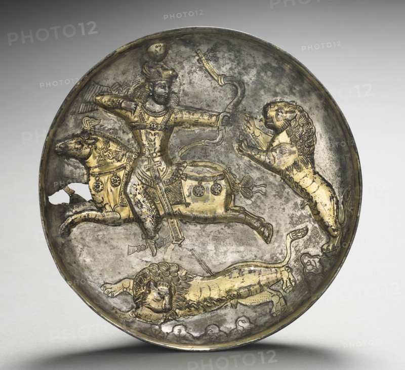 Dish:  King Hormizd II or Hormizd III Hunting Lions, 400-600. Iran, Sasanian, 5th-6th Century. Silver gilt; overall: 4.6 x 20.8 cm (1 13/16 x 8 3/16 in.).
