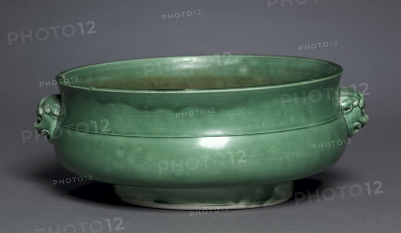 Bowl in Form of Archaic Gui, 1628-1661. China, Jiangxi province, Jingdezhen, Ming dynasty, Jiajing mark (1522-1566) but Chongzhen period (1628-1644) or Qing dynasty, Shunzhi period (1644-1661). Porcelain with camellia-leaf green glaze; diameter: 23.4 cm (9 3/16 in.); overall: 9 cm (3 9/16 in.).