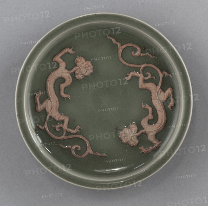 Dish with Two Dragons in Relief:  Longquan Ware, 14th Century. China, Zhejiang province, Yuan dynasty (1271-1368). Glazed porcelain with unglazed molded decoration; diameter: 16.5 cm (6 1/2 in.).