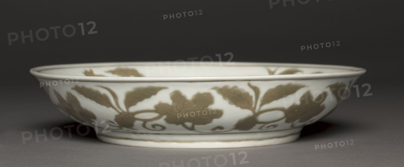 Dish with Flowers and Fruit, 1488-1505. China, Jiangxi province, Jingdezhen kilns, Ming dynasty (1368-1644), Hongzhi mark and reign (1488-1505). Porcelain with incised and underglaze coffee brown (iron oxide) decoration; diameter: 25.8 cm (10 3/16 in.); overall: 26 cm (10 1/4 in.).
