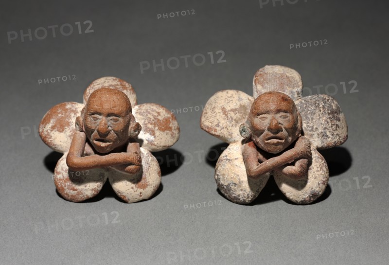 Pair of Figure in Flower Ornaments, 500-900. Mexico, Yucatán, Jaina Island region, Campeche, Maya style (250-900). Earthenware with slip; diameter: 3 cm (1 3/16 in.).
