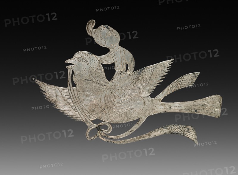 Inlay for a Mirror or Box: Lady on a Bird, c. 900-1000. China, Tang dynasty (618-907) - Song dynasty (960-1279). Beaten silver with chased details; overall: 5.3 x 8.4 cm (2 1/16 x 3 5/16 in.).