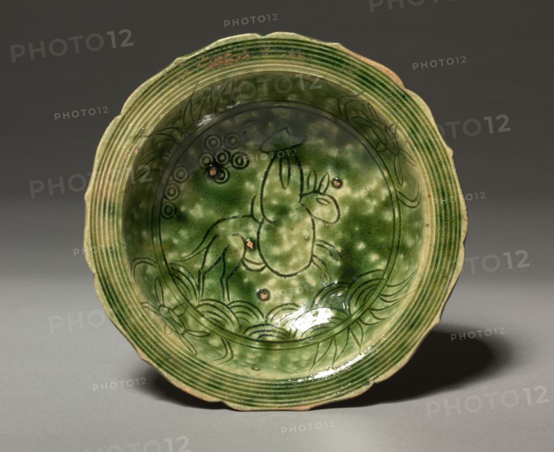 Dish with Incised Design of a Rider on a Mule:  Oribe Ware, c. 1600. Japan, Gifu Prefecture, Mino kilns, Momoyama period, 1573-1615. Buff stoneware covered with copper-green glaze; diameter: 16.7 cm (6 9/16 in.).