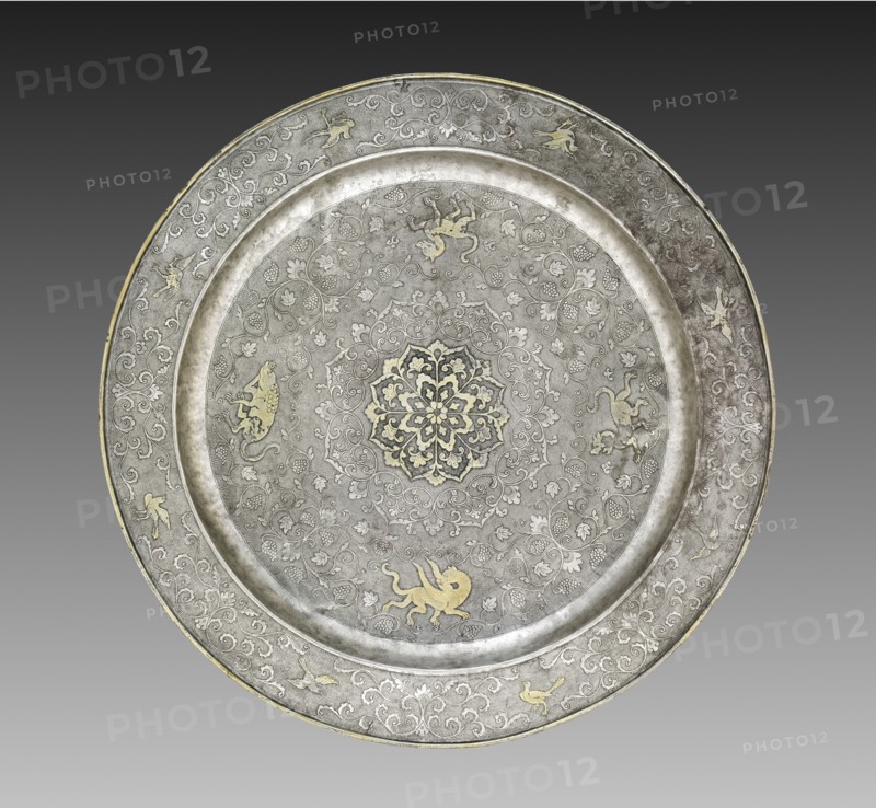 Footed Platter with Design of Mythical Beasts amid Grapevines, 700s. China, Tang dynasty (618-907). Silver with gilt, incised, and chased decoration; diameter: 30.5 cm (12 in.).