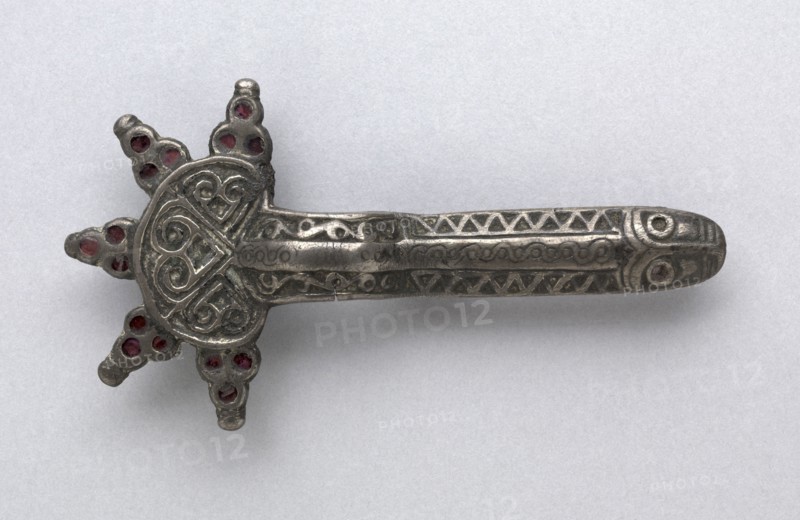 Fibula, 500s. Frankish, Migration period, 6th century. Silver with garnets; overall: 11 x 6 x 1.6 cm (4 5/16 x 2 3/8 x 5/8 in.).