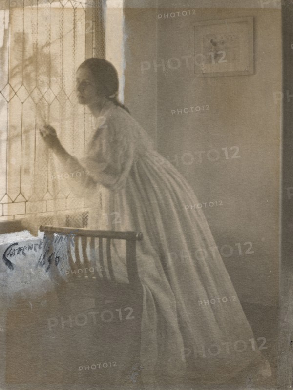At the Window, 1896. Clarence H. White (American, 1871-1925). Platinum print with watercolor and gouache; image: 20.3 x 15.4 cm (8 x 6 1/16 in.); matted: 45.7 x 35.6 cm (18 x 14 in.)