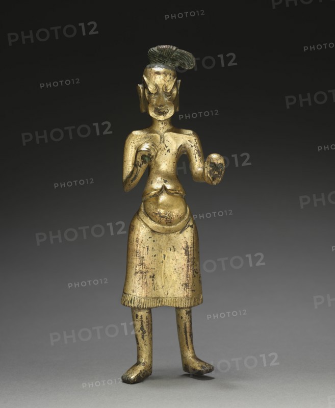 Ascetic Holding a Skull, c. 500. China, Northern Wei dynasty (386-534). Gilt bronze; overall: 19.4 cm (7 5/8 in.); figure: 18.1 cm (7 1/8 in.).