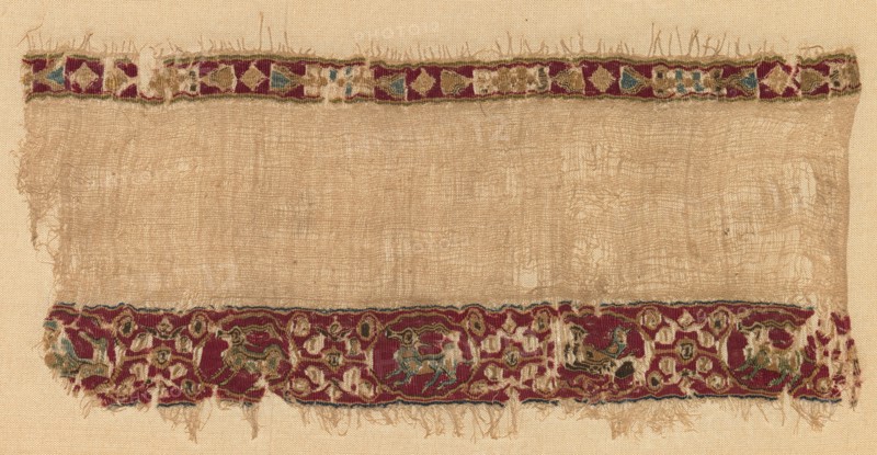 Fragment of a Tiraz-Style Textile, late 1000s. Egypt, Fatimid period, late 11th century. Tabby ground with inwoven tapestry ornament; linen and silk; overall: 10 x 20.6 cm (3 15/16 x 8 1/8 in.)