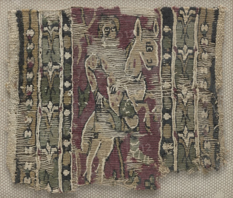 Fragment of a Clavus with Man on Horseback, 700s. Egypt, 8th century. Tapestry; linen and wool; overall: 11.5 x 10 cm (4 1/2 x 3 15/16 in.)
