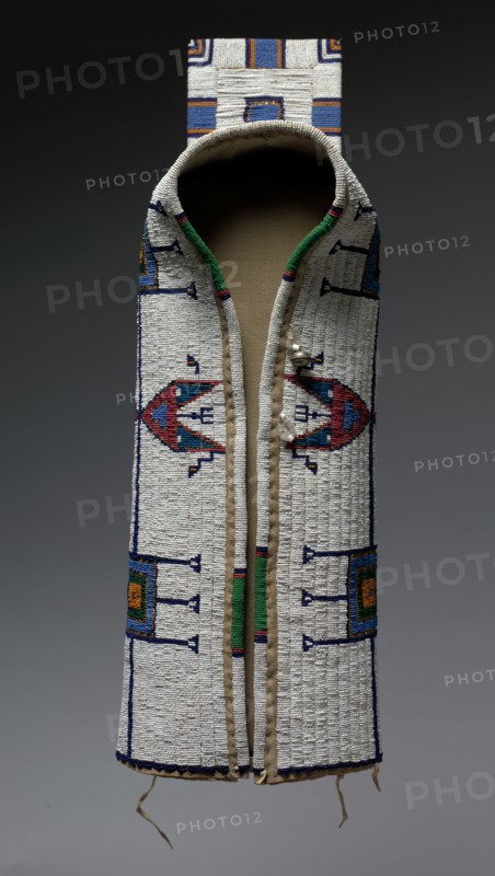 Cradle or Carrier, c. 1900. America, Native North American, Plains, Lakota (Sioux) people, Post-Contact. Native-tanned hide, cotton cloth, glass beads, metal beads, brass bell, sinew thread, cotton thread; overall: 22.9 x 25.4 cm (9 x 10 in.).