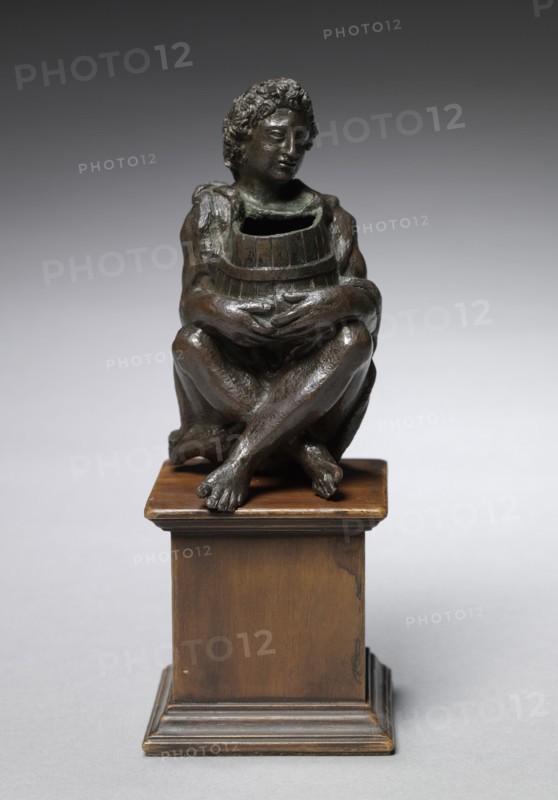 Seated Boy Clothed with Goat Skins Holding an Open Barrel, c. 1525. Italy, Padua, 16th century. Bronze; overall: 11.2 x 6 x 6.5 cm (4 7/16 x 2 3/8 x 2 9/16 in.).