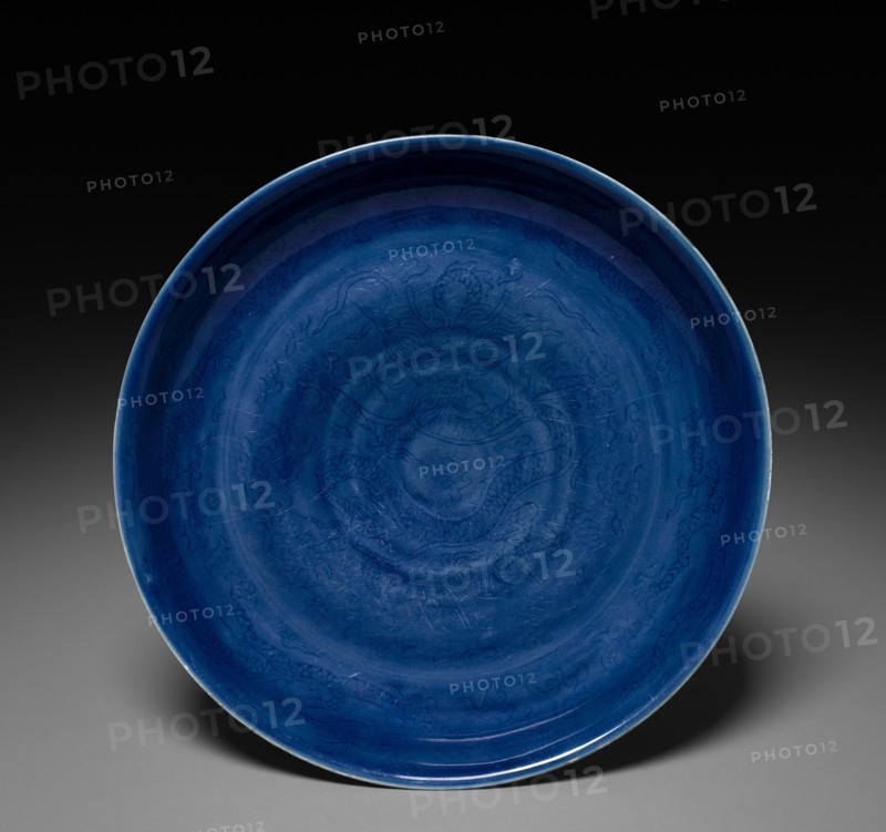 Dish with Dragon and Clouds, 1522-1566. China, Jiangxi province, Jingdezhen kilns, Ming dynasty (1368-1644), Jiajing mark and reign (1521-1566). Porcelain with incised and underglaze blue decoration; diameter: 28.4 cm (11 3/16 in.).