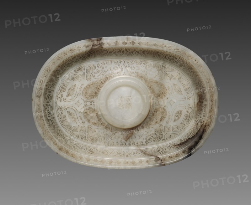 Oval Cup Stand with Animal Masks, 1736-1795. China, Qing dynasty, Qianlong mark and period (1736-1795). White jade with black markings and incised decoration; overall: 10.5 cm (4 1/8 in.).