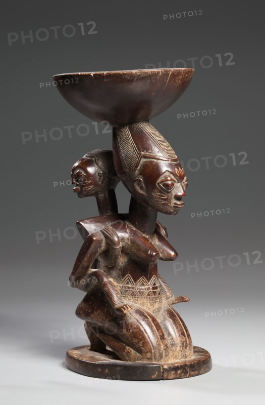 Mother-and-Child Caryatid Vessel, mid-late 1800s. Guinea Coast, Nigeria, Yoruba, mid-late 19th century. Wood; overall: 31.7 x 15.7 x 15.9 cm (12 1/2 x 6 3/16 x 6 1/4 in.)