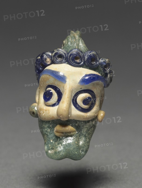 Head Pendant, 600-500 BC. Lebanon, Syro-Phoenicia, 6th - 5th centuries B.C.. Glass; overall: 3.5 x 2.1 x 1.9 cm (1 3/8 x 13/16 x 3/4 in.).