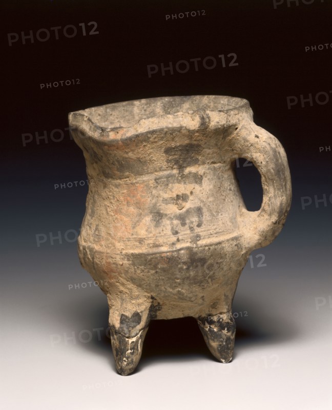Wine Warmer (Jue), c. 1300-1023 BC. China, Shang dynasty (c.1600-c.1046 BC), Anyang phase (c.1250-1046 BC). Pottery, tripod vessel with loop handle and rudimentary bowstring decoration; diameter: 13.4 cm (5 1/4 in.); overall: 11.7 cm (4 5/8 in.).