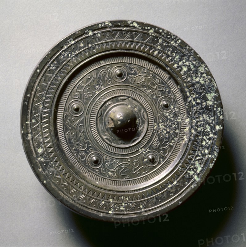 Mirror with Concentric Circles, an Immortal, and Auspicious Animals, 1st century BC-1st century AD. China, Western Han dynasty (202 BC-AD 9). Bronze; diameter: 13.8 cm (5 7/16 in.); overall: 1 cm (3/8 in.); rim: 0.5 cm (3/16 in.).