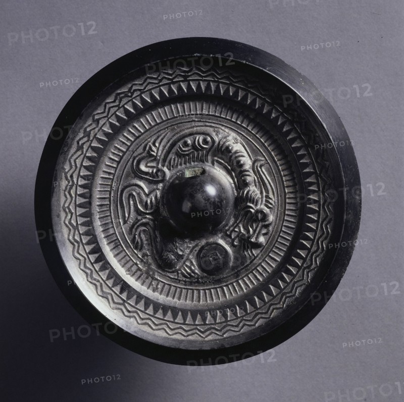 Mirror with a Coiling Dragon, 3rd Century. China, Three Kingdoms (221-280). Bronze; diameter: 9.9 cm (3 7/8 in.); overall: 1 cm (3/8 in.); rim: 0.8 cm (5/16 in.).