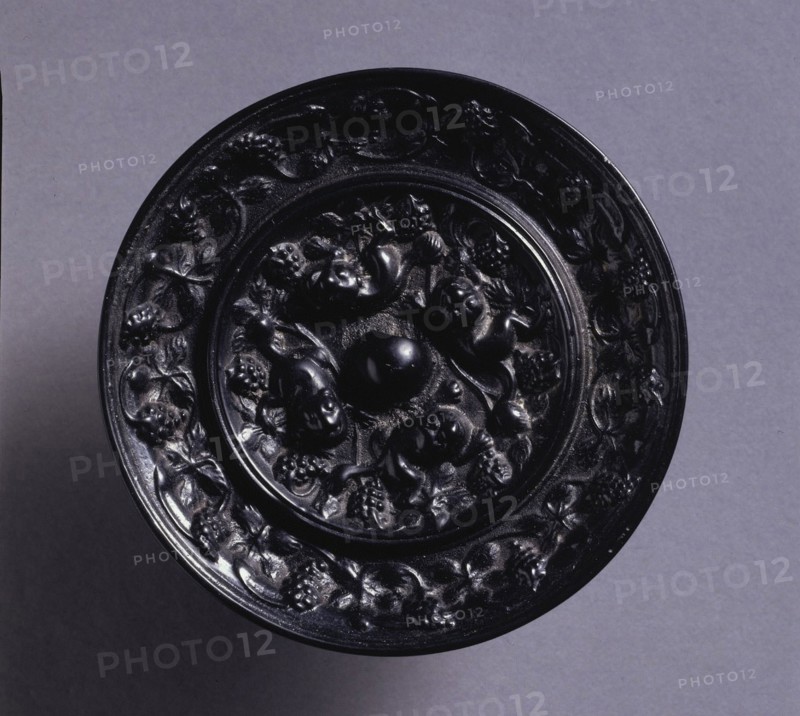 Animal-and-Grape Mirror, mid 600s. China, Tang dynasty (618-907). Bronze; diameter: 8.2 cm (3 1/4 in.); overall: 1 cm (3/8 in.); rim: 1 cm (3/8 in.).