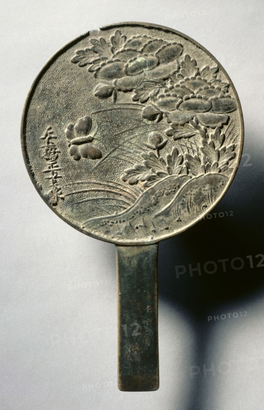 Mirror with Handle, Decorated with a Butterfly and Blooming Peony, early 17th - mid19th century. Japan, Edo (1615-1868). Bronze; diameter: 14.5 cm (5 11/16 in.); overall: 0.5 cm (3/16 in.); rim: 0.5 cm (3/16 in.).