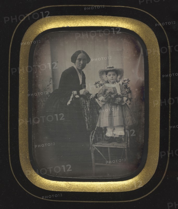 Child Standing on a Chair Holding Flowers, with Mother, c. 1855. Unidentified Photographer. Daguerreotype, quarter-plate; image: 9.2 x 7.1 cm (3 5/8 x 2 13/16 in.); framed: 15.4 x 12.7 cm (6 1/16 x 5 in.); matted: 45.7 x 35.6 cm (18 x 14 in.)